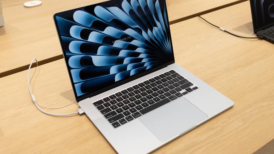 How does using your MacBook while charging affect its battery life?